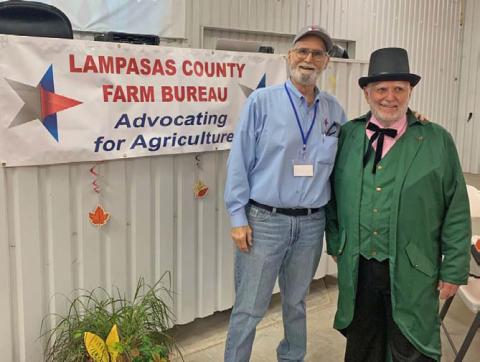 Lampasas County Farm Bureau Director and Public Relations Chairman Dr. Steve Forsythe, at left, greets the keynote speaker, Lampasas native Dr. Gary Moore of North Carolina, who dressed as the Wizard of Oz for his presentation at the county convention. COURTESY PHOTO