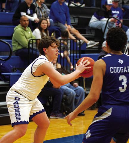 Aidan Nuckles looks for a teammate to pass to during the game. The freshman is deep into his first varsity season. HUNTER KING | DISPATCH RECORD