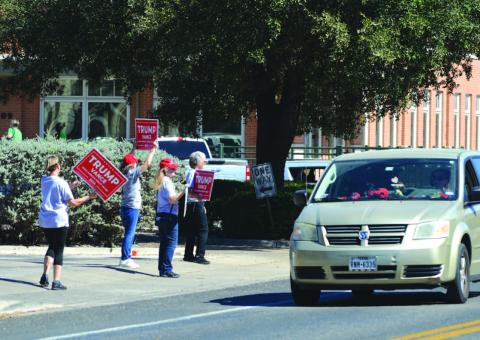 ERICK MITCHELL | DISPATCH RECORD Volunteers campaigned in downtown Lampasas this week for their favorite candidates and encouraged voter participation. Many East Fourth Street drivers honked in recognition of the push for early voting.