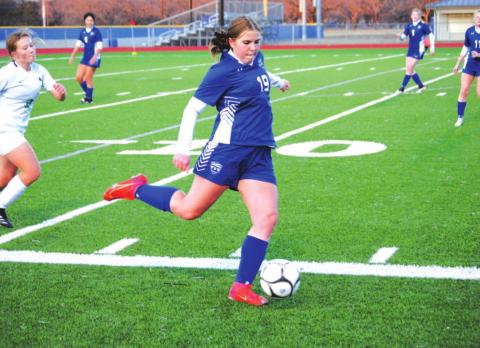 Ava Dowdy swings her leg to clear the ball from her own end in the Lady Badgers’ loss to Burnet. HUNTER KING | DISPATCH RECORD