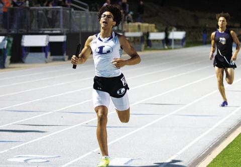 Ty Johnson crosses the finish line to win the 4x400-meter relay at the district track meet last week. HUNTER KING | DISPATCH RECORD