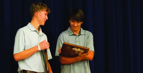 HUNTER KING | DISPATCH RECORD From left, Jonas Andersen and Calvin Phelps check out their team awards at the baseball banquet on Tuesday.