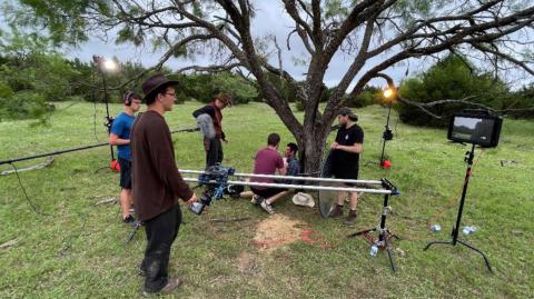 A film crew based out of Des Moines, Iowa gathers around a tree on the Crain/VanNatta-8-Ranch in Lampasas County while working on its production of “Big Iron.” COURTESY PHOTO