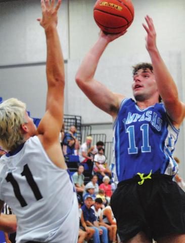 Carter Johnson goes over a defender during summer league. HUNTER KING | DISPATCH RECORD