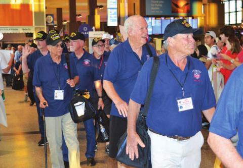 Veterans who participated in an Honor Flight to Washington, D.C. last week were greeted Saturday night by a large crowd at Austin’s Bergstrom International Airport upon their arrival back from the nation’s capital. Lampasas resident James Welch, left side of photograph holding a carry-on bag, served with the Marines during the Korean War. JIM LOWE | DISPATCH RECORD