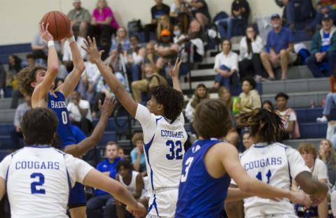 Nate Borchardt goes up over a Jarrell defender for a shot on his way to a 32-point night against the Cougars. HUNTER KING | DISPATCH RECORD