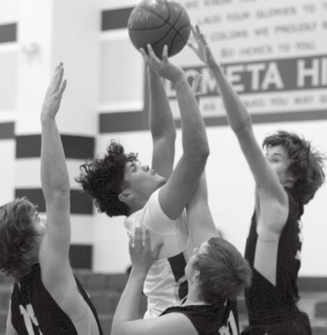 Elijah Gonzales shoots, surrounded by three Jonesboro defenders in the Lometa JV boys’ victory at home on Tuesday. JEFF LOWE | DISPATCH RECORD