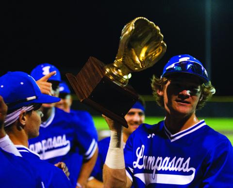 Timber Gholson shows off the gold glove from winning the area round of the playoffs. HUNTER KING | DISPATCH RECORD
