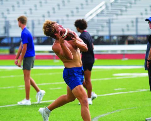 HUNTER KING | DISPATCH RECORD Haegan Oncken hauls in a pass during the hour of sport-specific workouts following SWAT on Wednesday morning.