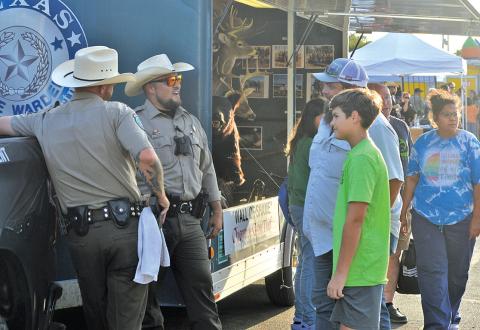 Lampasas residents stop by for a chat at the Texas Game Warden booth at last year’s National Night Out event. file photo