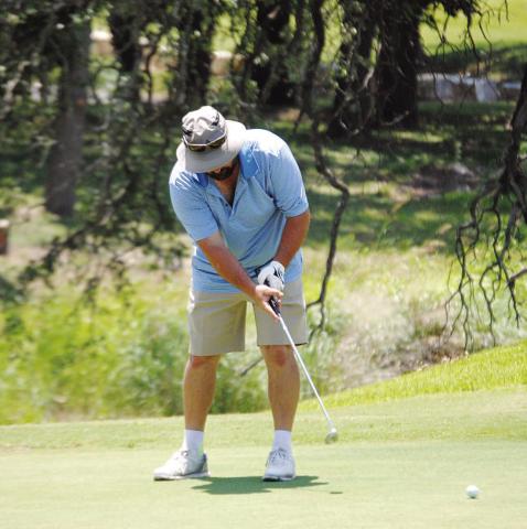 HUNTER KING | DISPATCH RECORD Gerry Spore hits a putt on the fifth green at Hancock Park Golf Course, home of the A.C. January Memorial Tournament.
