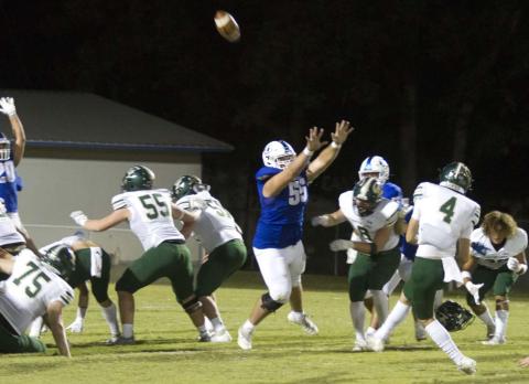 Connor Keele jumps and puts his hands up to try and block a kick attempt by Canyon Lake in last Friday’s game. HUNTER KING | DISPATCH RECORD