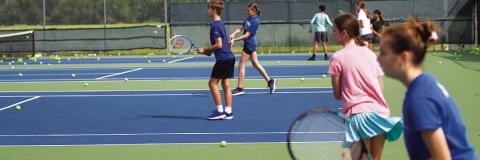 HUNTER KING | DISPATCH RECORD Young tennis players work on their shots during camp on Tuesday.