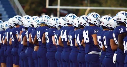 The Badger football team lines up before every game as the coin is tossed to begin each contest. HUNTER KING | DISPATCH RECORD