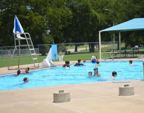 Swimmers of all ages cool off during a hot July at the Hanna Springs Pool. Upcoming events at the pool include the annual Dive-In Movie night and a Teen Scene social event. FILE PHOTO | DISPATCH RECORD