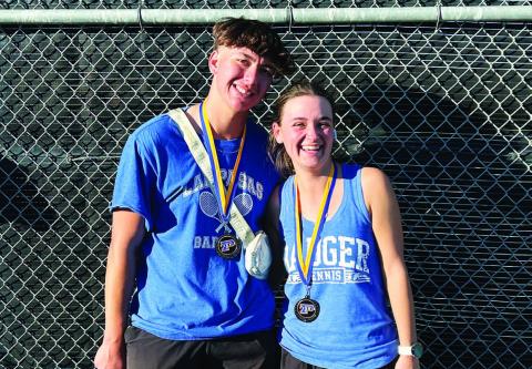 COURTESY PHOTO | KENNETH PEISER Clyde Ashfield, left, and Caroline White pose with their medals from last week’s tournament.