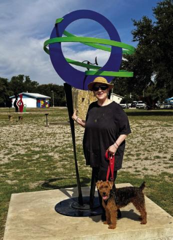 Michelle O’Michael stands by her sculpture “Honoring Trees” after it was installed in the Hanna Springs Sculpture Garden earlier this month. COURTESY PHOTO | LAFTA