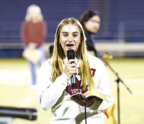 Lampasas high schooler Loretta Hodges reads from the Bible during last week’s Fields of Faith event. HUNTER KING | DISPATCH RECORD