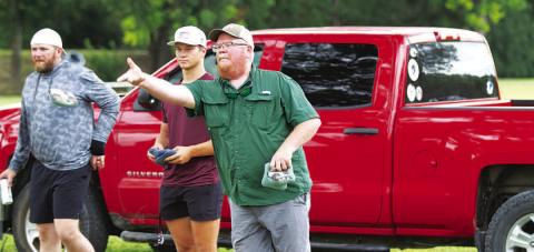 HUNTER KING | DISPATCH RECORD Trampus Isom tosses a bag during the cornhole tournament last Saturday.