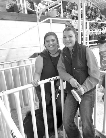 Ava Rojas, at left, stands alongside Emory Vineyard at the Lampasas County Youth Livestock Show in January. Vineyard credits Rojas for helping her improve at competitions. COURTESY PHOTO