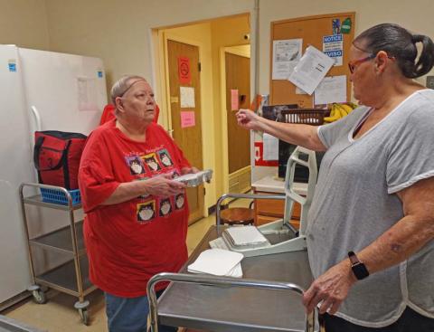 Lampasas Senior Center cook Theresa Waechter, left, and volunteer Marsha Schaffer work to prepare the day’s meals before they go out to those who participate in the program for homebound seniors. courtesy photo | Lampasas Senior Center
