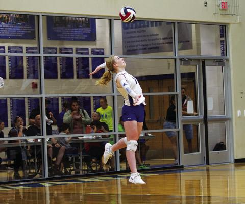 Ellie Felkner serves during the Lady Badger volleyball team’s match against Jarrell.