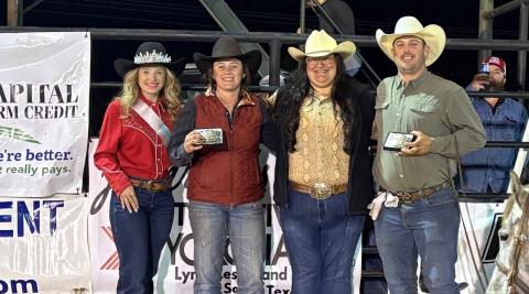 Rodeo Queen Karlee Parker, at left, helps congratulate the team roping winners as they show off their buckles. The event was sponsored by Capital Farm Credit of San Saba. COURTESY PHOTO | TERRI HARRIS