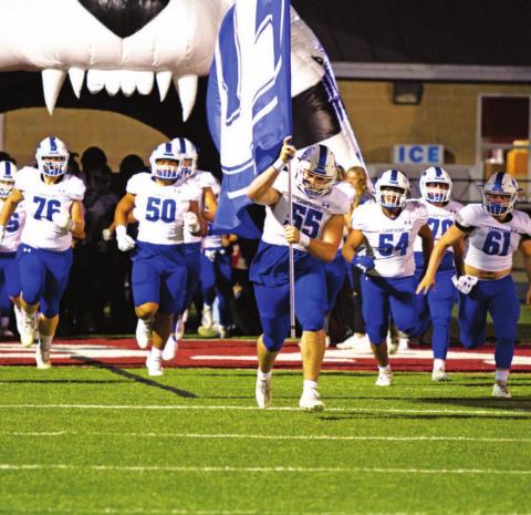 Conner Keele leads the Badgers onto the field in their final regular-season game of 2021 against Fredericksburg. FILE PHOTO