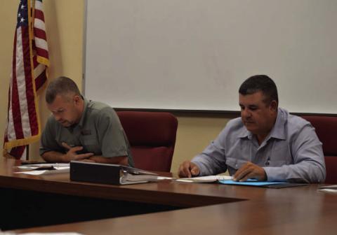 Lampasas Central Appraisal District Board of Directors chairman Marshal Brewer, at left, and board member Chris Harrison pour over budget numbers proposed for the 2026 fiscal year. ERICK MITCHELL | DISPATCH RECORD