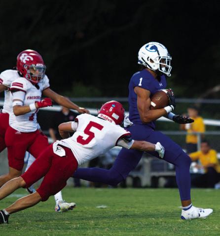 HUNTER KING | DISPATCH RECORD Ty Johnson runs away from Fredericksburg defenders for a touchdown in the first quarter.
