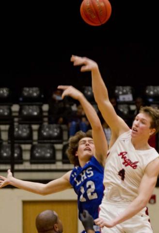 Landon Mulcahy, left, tips off against 6’7” Argyle senior Nate Atwood in the area championship, which Argyle won 65-45. JEFF LOWE | DISPATCH RECORD