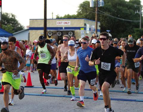 10K runners take off from the starting line at last Saturday’s event.