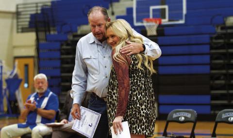 Keaton Owen gets a hug from assistant coach Doug Messer after getting her award. HUNTER KING | DISPATCH RECORD