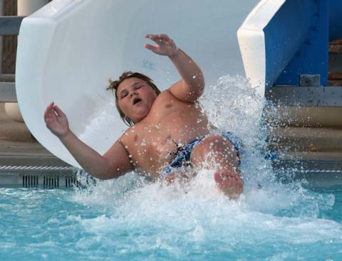Zane Lee uses the water slide during the Teen Scene event at the Hanna Springs Pool on Saturday. JOSEPH NEUENSCHWANDER | LAMPASAS DISPATCH RECORD
