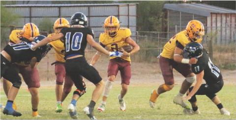 Stone Carr-Jones (2) looks for room to run while Lukas Smailus-Cruz (22), Jacob Wooten (25, far left) and Jordan Livesay (3, middle) set up blocks. MEGAN LUSTY | COURTESY PHOTO
