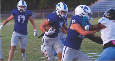 HUNTER KING | DISPATCH RECORD Jett Walker follows the block of Bryson Roberts in the first quarter of last Friday’s win.