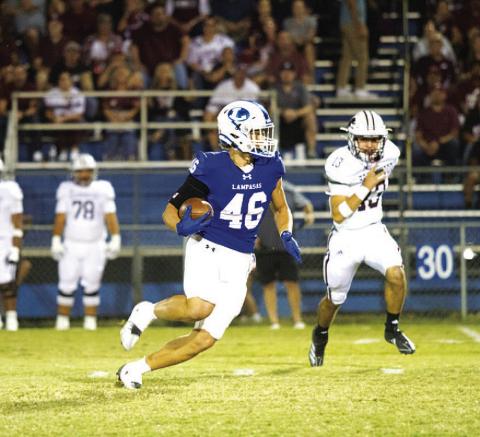 HUNTER KING | DISPATCH RECORD Haegan Oncken runs away from a Brownwood defender early in last Friday’s game.