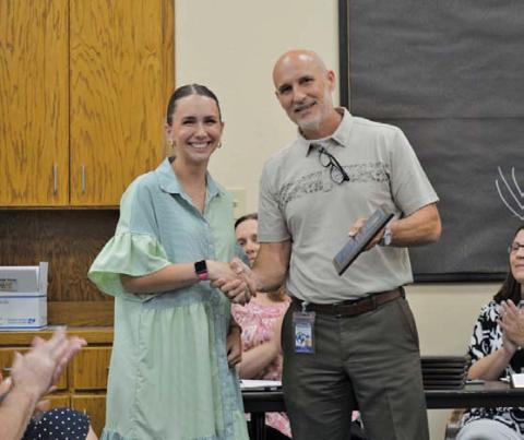 Taylor Creek Elementary School teacher of the year Lauren Robinson receives her plaque of achievement from Assistant Superintendent Dana Holcomb. Lampasas ISD’s Teachers of the Year for 2025 were recognized at Monday’s Board of Trustees regular meeting. ERICK MITCHELL | DISPATCH RECORD
