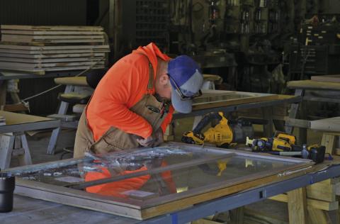 ERICK MITCHELL | DISPATCH RECORD Adam Morrison of RKJ Construction works on one of the downstairs courthouse windows. The windows are being removed in sections and taken off-premises for reglazing.
