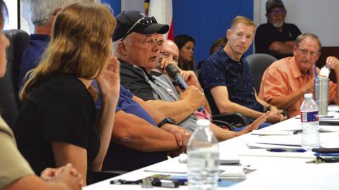 Kempner Water Supply Corp. board president Dennis Kliza, in center with microphone, responds to member concerns during last Wednesday’s regular meeting. ERICK MITCHELL | DISPATCH RECORD