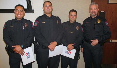 Lampasas Police Chief Jody Cummings (far right) congratulates new cadets, from left to right, John Reza, Jameson Varnado and Brandon English at the Central Texas College Police Academy graduation ceremony. courtesy photo