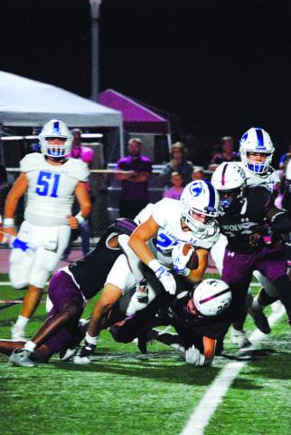 Jett Walker falls forward for extra yards on a run against Davenport last Friday. HUNTER KING | DISPATCH RECORD