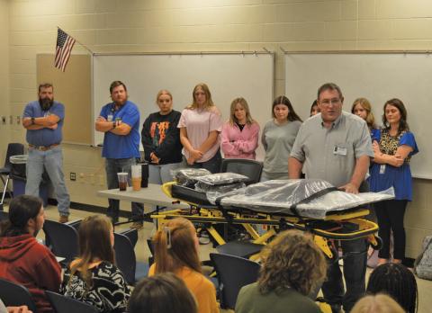 Creating Badger Builders President Herb Pearce speaks to students after the non-profit organization donated a new ECG simulator and stretcher on Tuesday for various CTE programs. erick mitchell | dispatch record