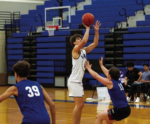 HUNTER KING | DISPATCH RECORD Calum Mitchell shoots a three-point shot during a recent practice. Basketball season is officially underway.