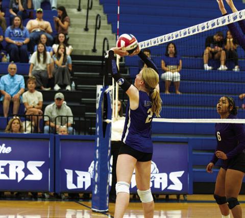 Ellie Felkner sets the ball up for a spike during the match against Florence. HUNTER KING | DISPATCH RECORD