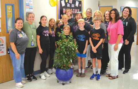 erick mitchell | dispatch record Fifth-grade Kline Whitis Elementary School students presented a tree last week to Hanna Springs Elementary in remembrance of former school nurse Tobi King.