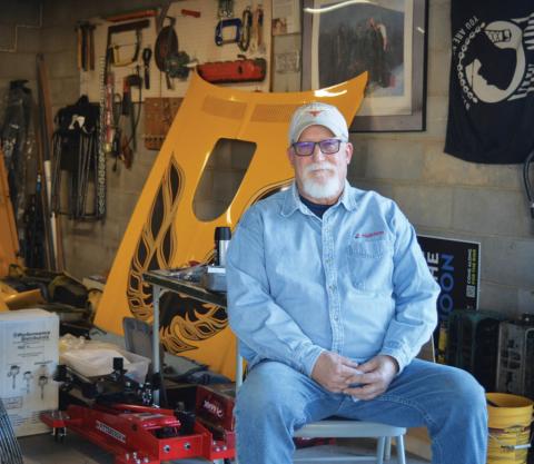 erick mitchell | dispatch record Lampasas resident Howard Tucker takes a seat outside his garage as the hood of the 1976 Pontiac Trans Am he is restoring rests in the background. Tucker, an engineer by trade, has a passion for classic automobiles.