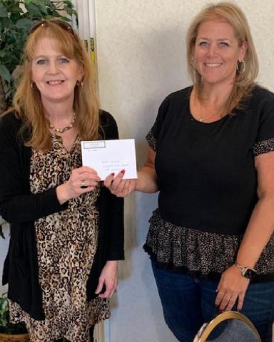 Julie Salvato, coordinator of Career and Technical Education for the Lampasas school district, accepts a check from ’36 Club President Danielle Shepard. COURTESY PHOTO