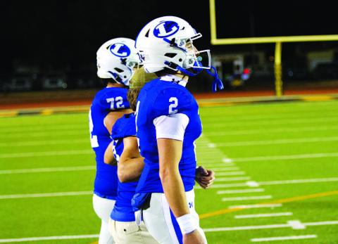 HUNTER KING | DISPATCH RECORD Bryson Roberts and his fellow captains head out for the coin toss last Friday.