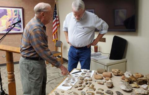 Former mayor Jack Calvert, left, and Lampasas County Historical Commission member Boyce Cabaniss talk about artifacts Cabaniss has unearthed across the area. The historian offered a special presentation last week at the library. LENORA ISENHOUR | COURTESY PHOTO